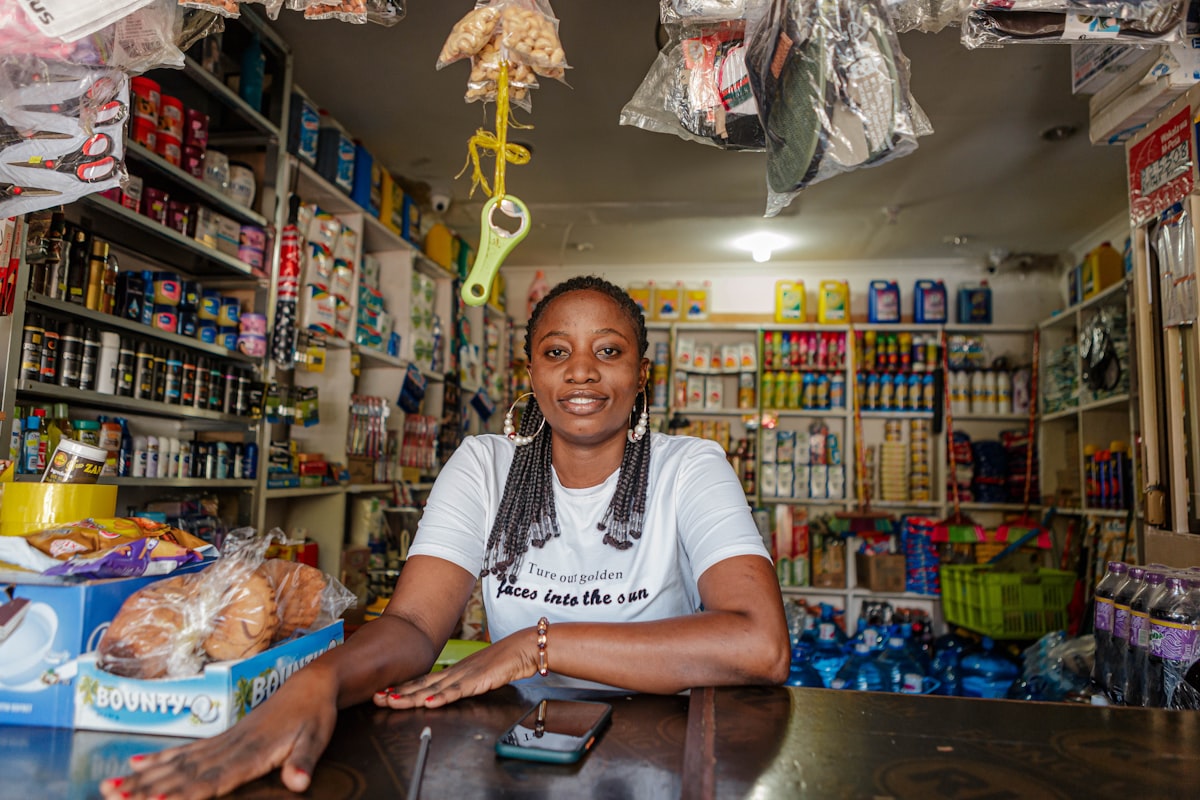 A shop owner smiling behind her counter